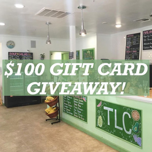 A photo of the front counter of a cafe, with text overlaid reading $100 gift card giveaway!